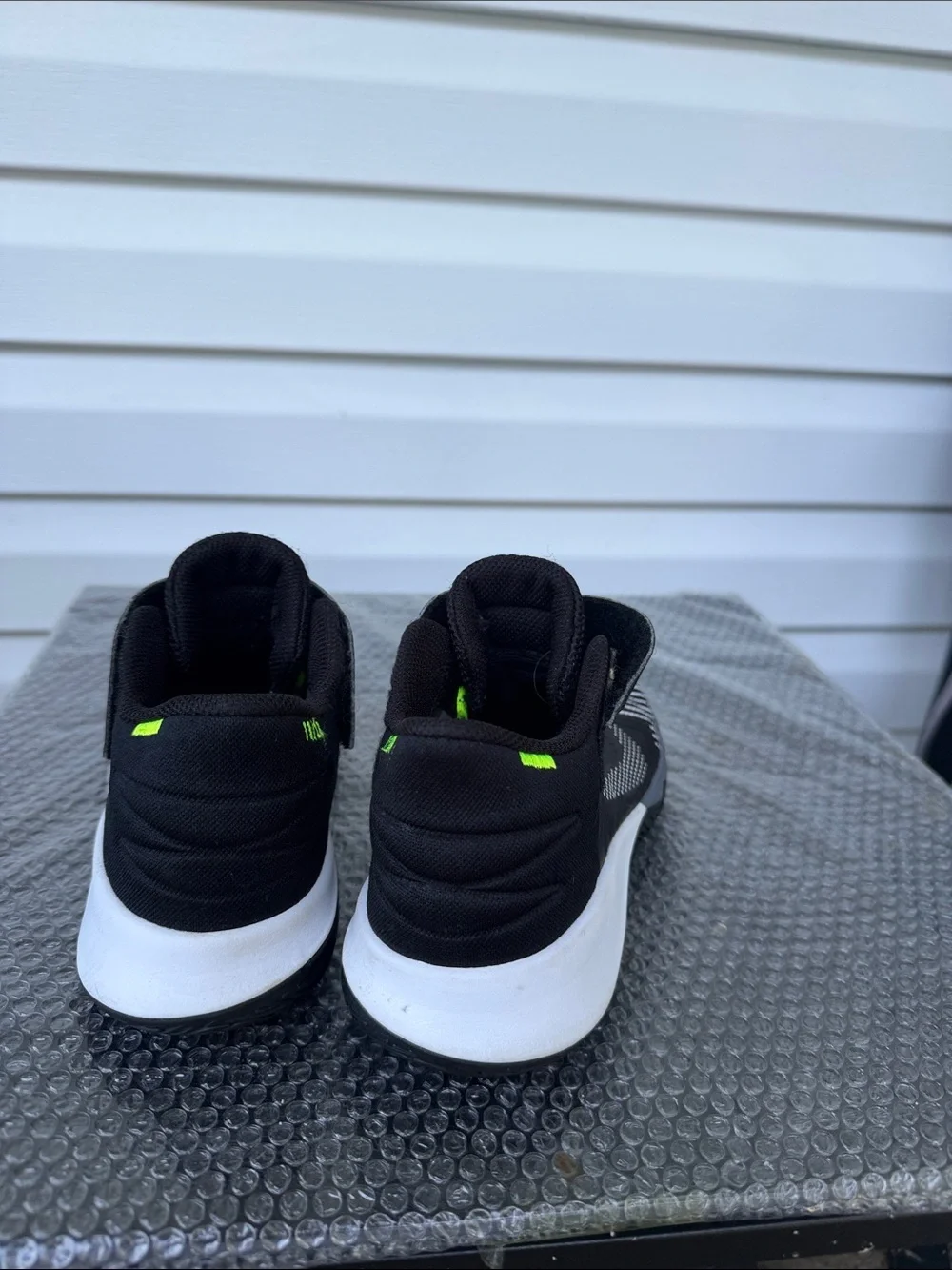 Nike Kids Black and White High-Top Sneakers with Neon Accent